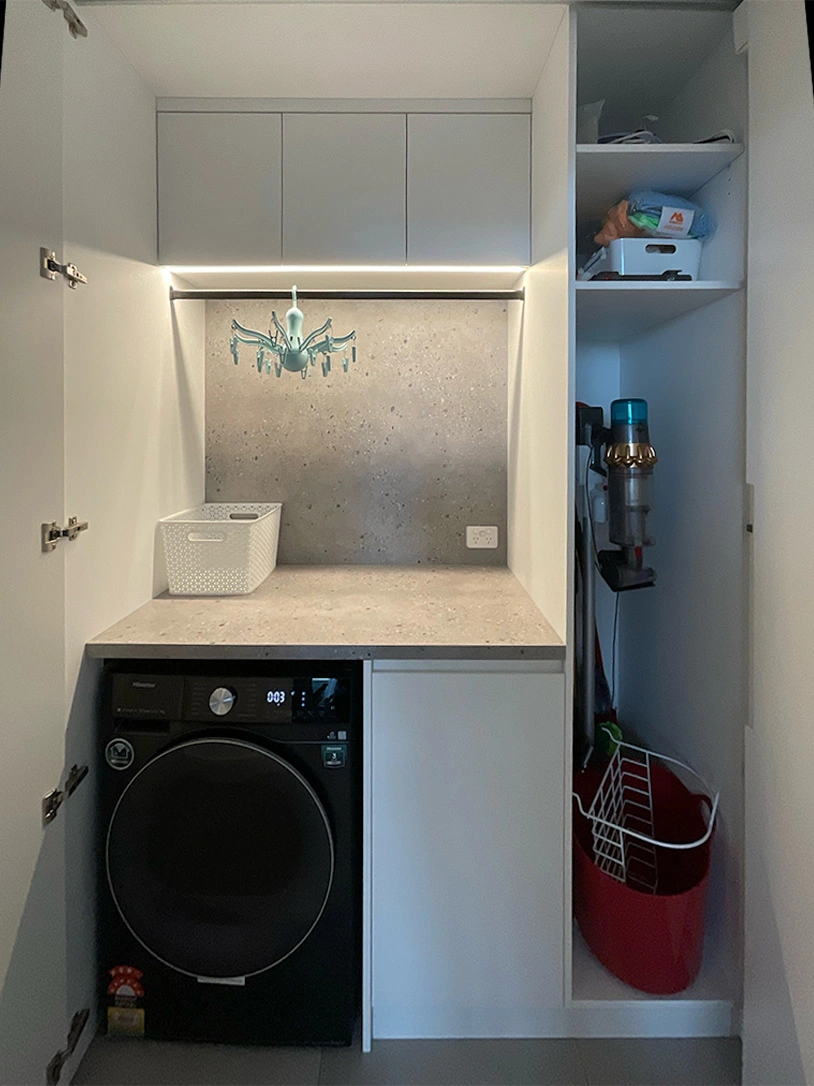 A compact laundry room featuring a washer and dryer, neatly arranged for efficient use of space