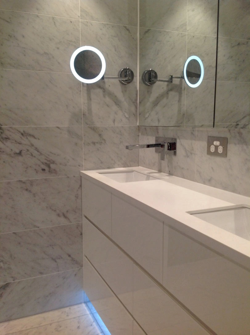 Stylish modern bathroom showcasing polished marble walls and a minimalist white sink