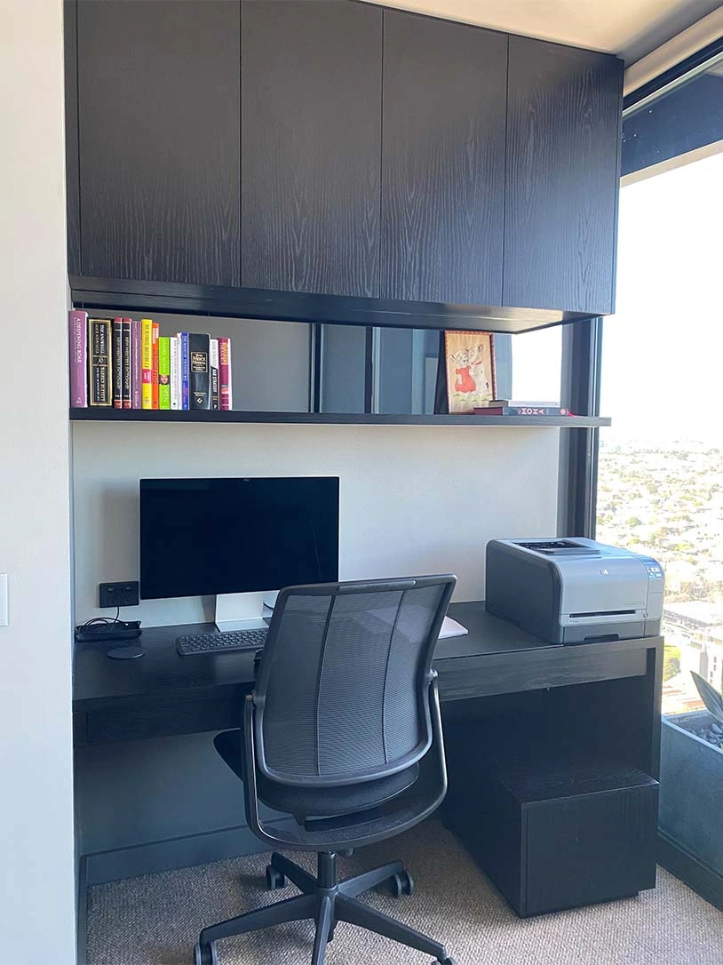 A modern home office environment with a desk and computer