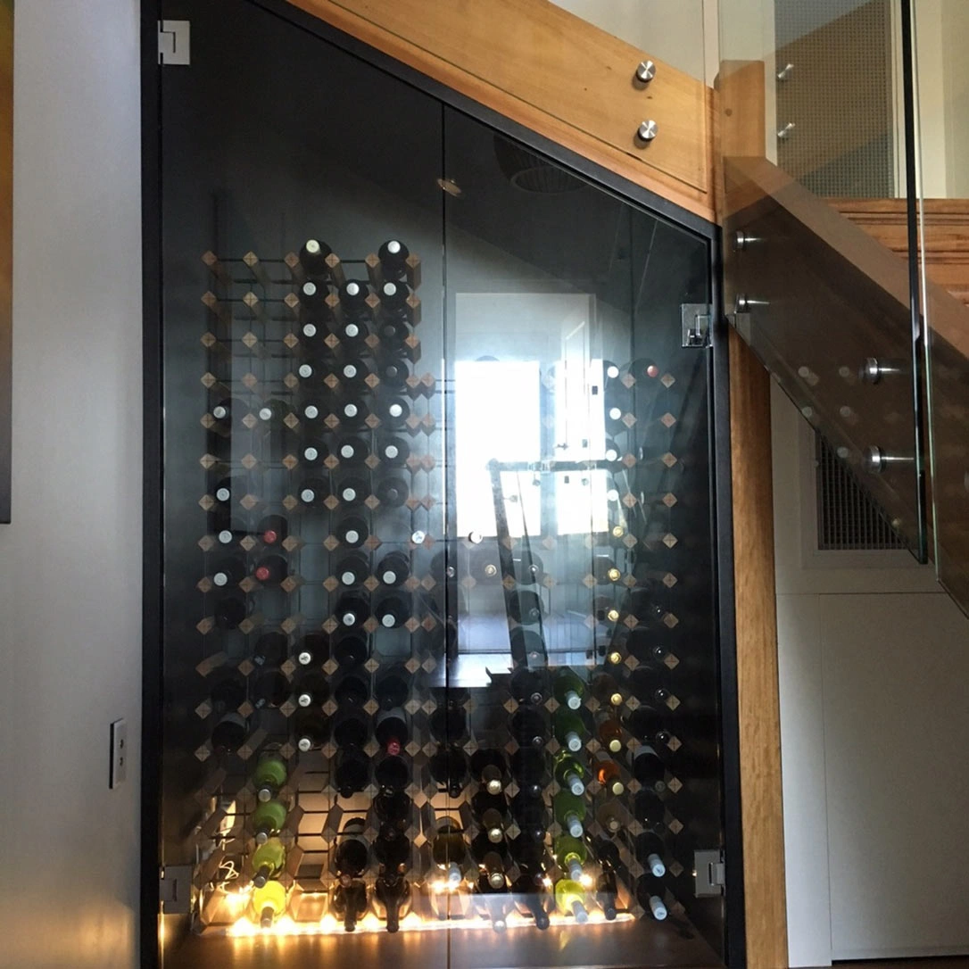 A modern wine cellar with glass doors and stairs, offering a glimpse of a well-organized collection of premium wines