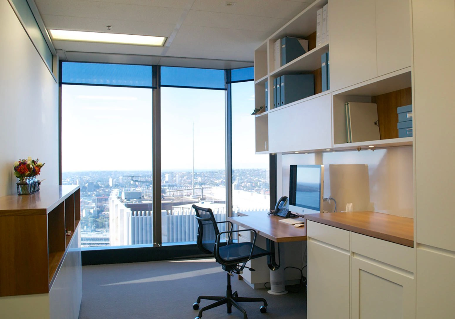 A well-lit home office showcasing a desk beside a window, perfect for productivity and natural light