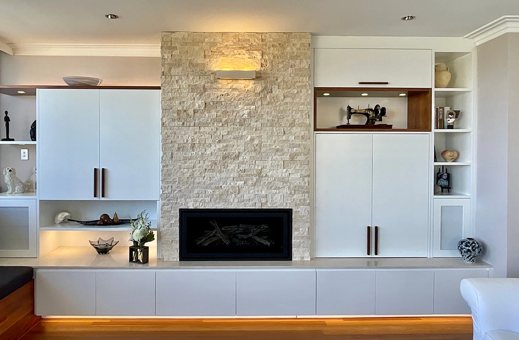 Modern living room with pristine white walls and a classic fireplace, offering a warm and inviting ambiance