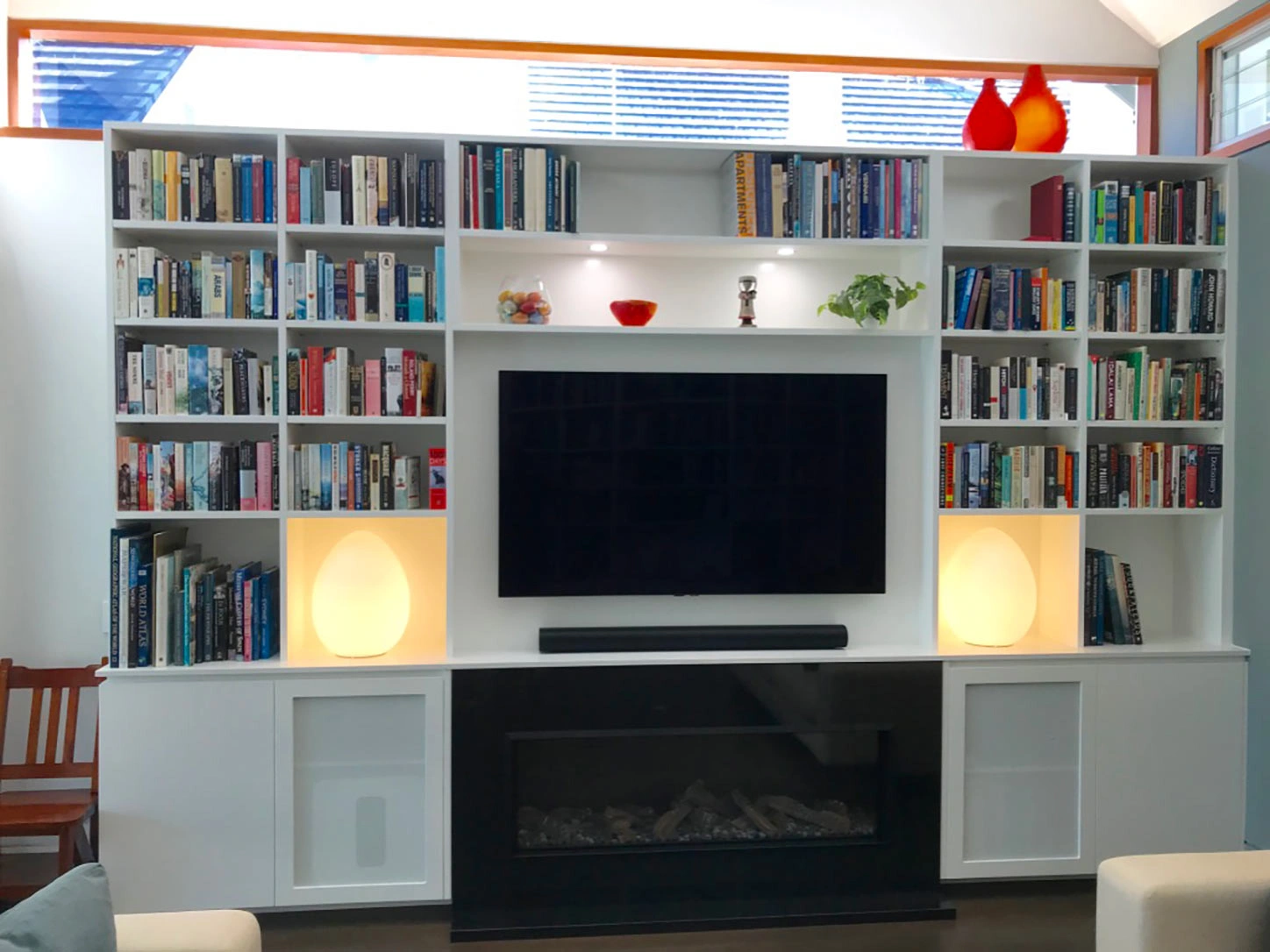 A beautifully arranged living room with a fireplace and bookshelves