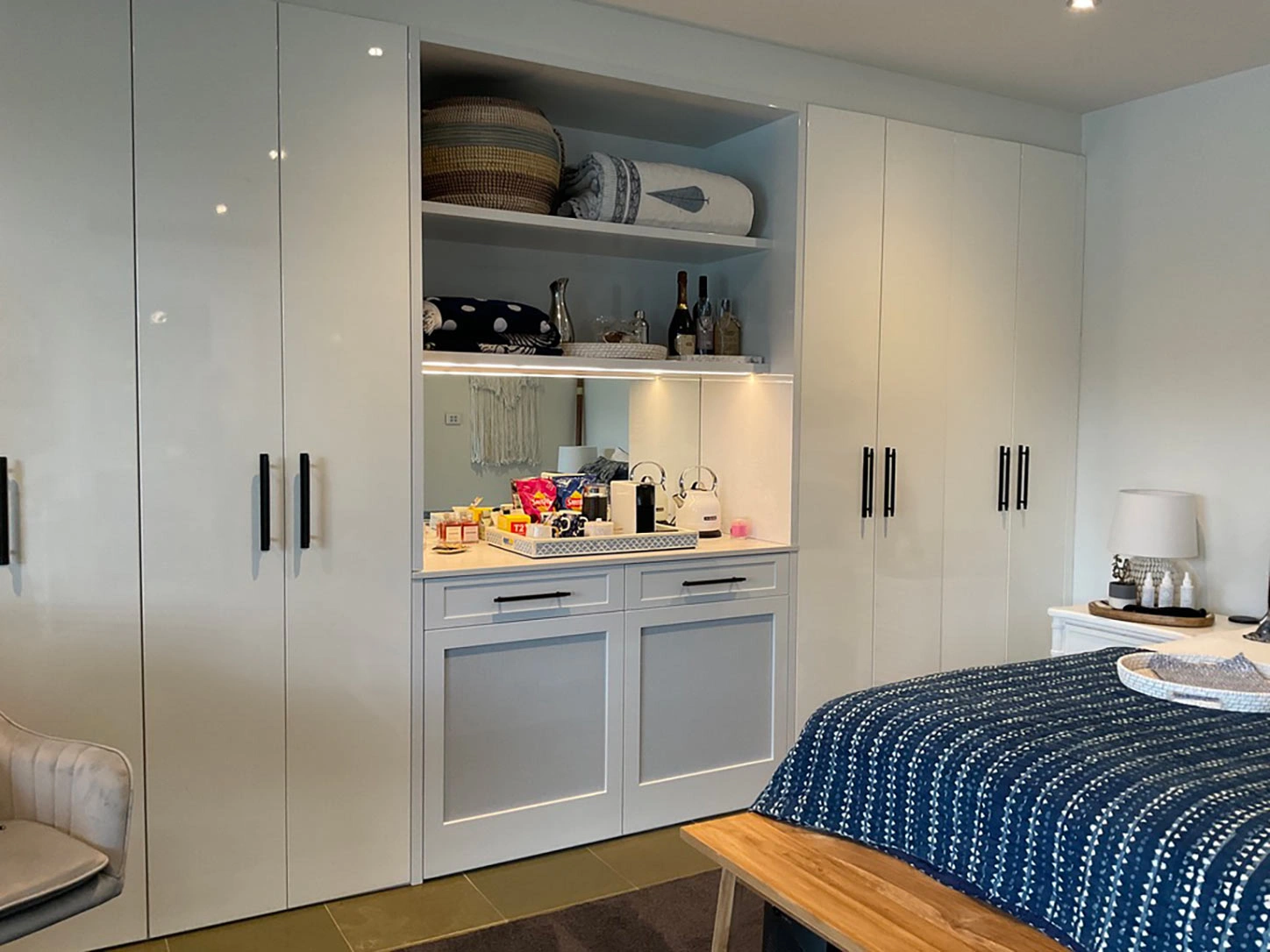 Modern bedroom with sleek white cabinets and a plush bed