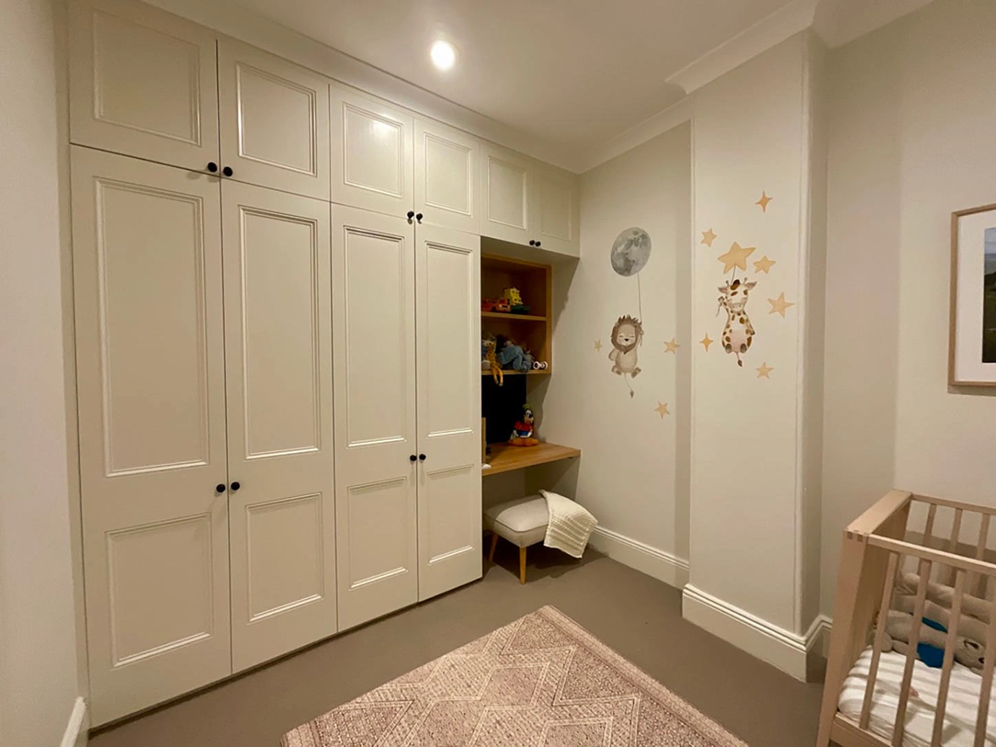 Well-organized nursery with a crib, dresser, and closet, providing a safe and nurturing environment for a baby