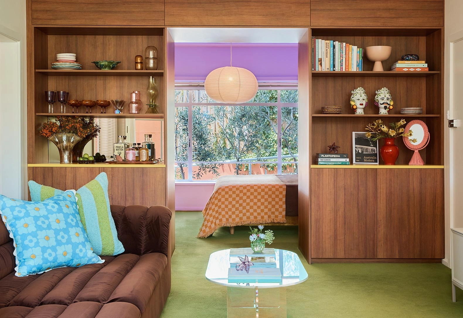 A welcoming living room showcasing a plush couch, a well-stocked bookshelf, and a chic coffee table