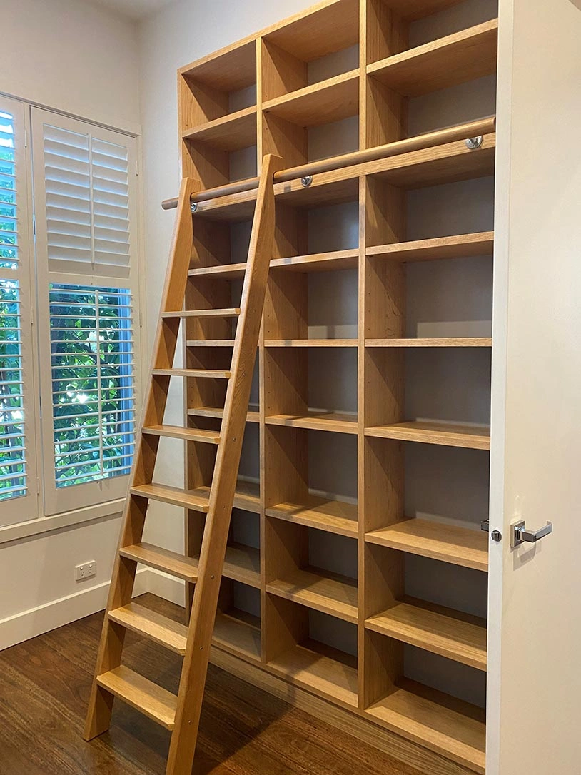 A lone ladder is positioned in the center of a room, highlighting the simplicity of the surrounding area