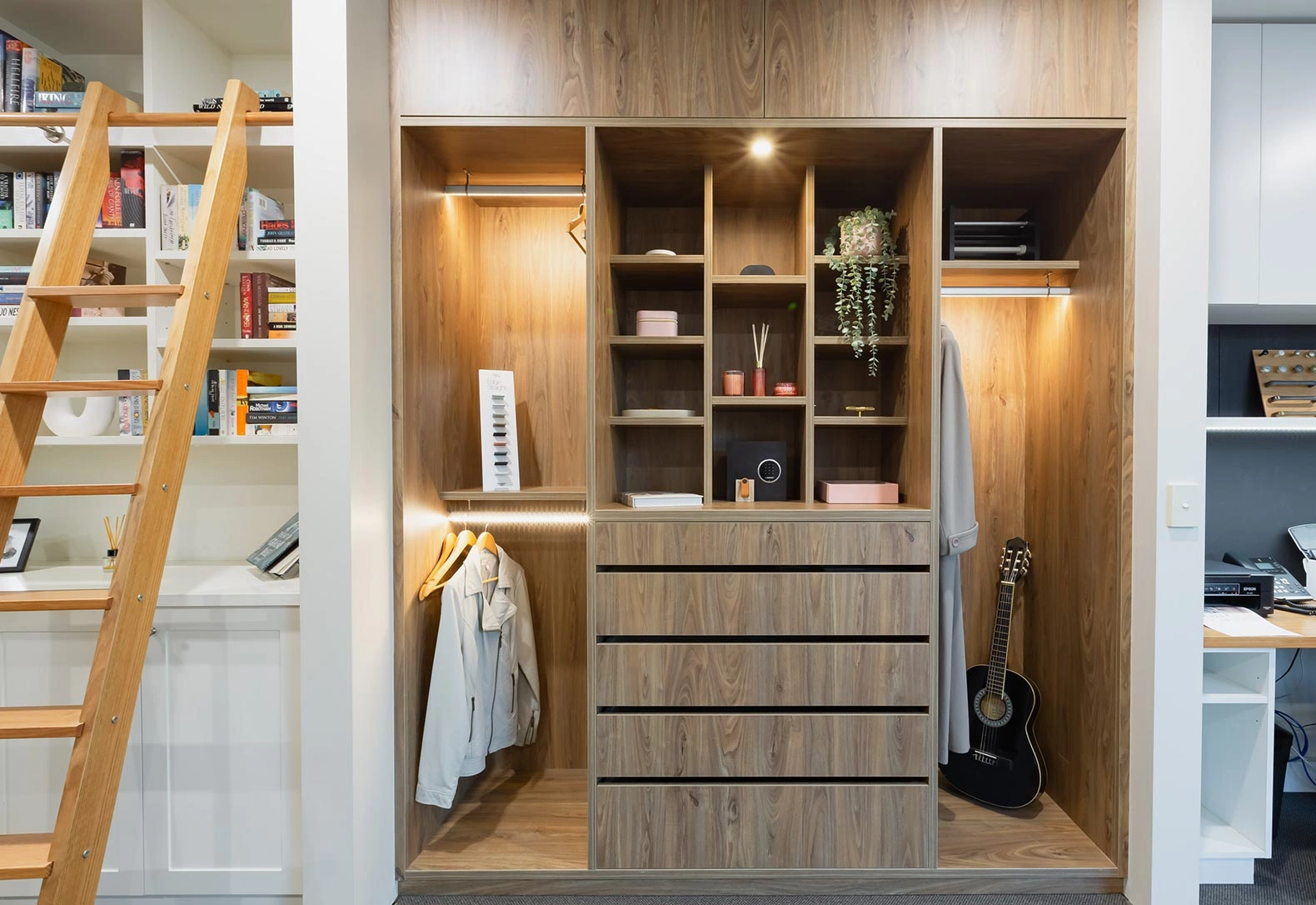 Modern walk-in closet with sleek wooden shelves, displaying a well-organized collection of clothes and personal items