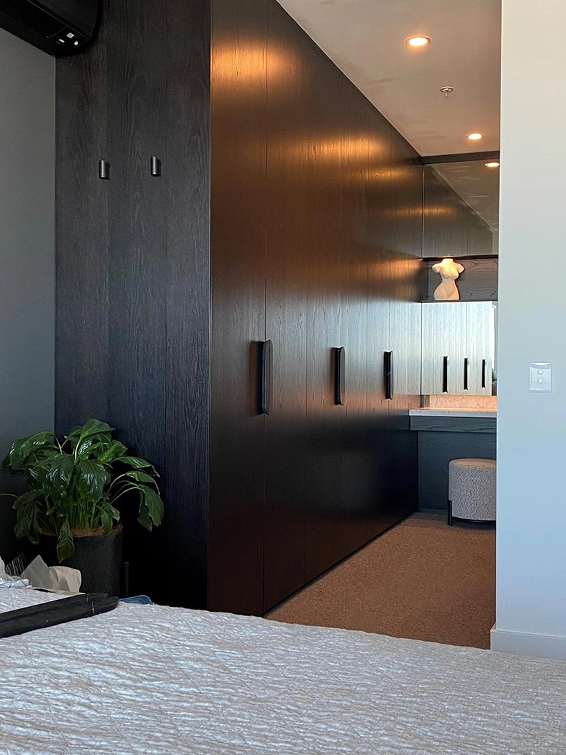 A well-lit room showcasing a large closet and a lamp