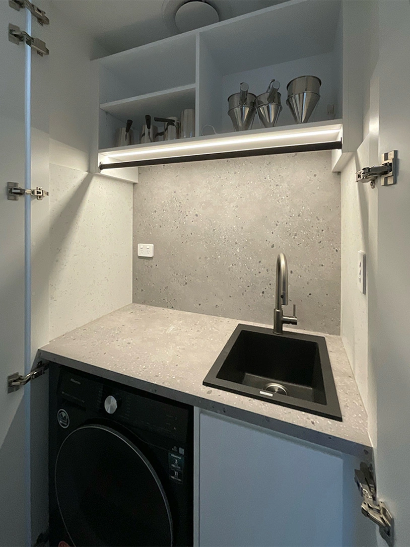 A small kitchen scene displaying a sink and dishwasher, illustrating a blend of convenience and style