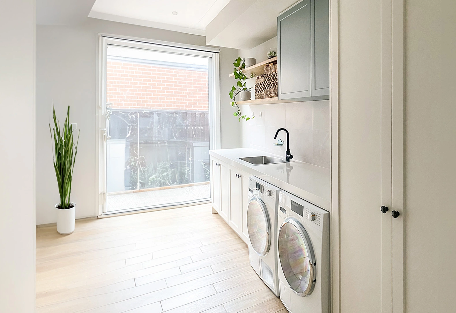 A well-organized laundry room showcasing a washer and dryer, designed for convenience and functionality