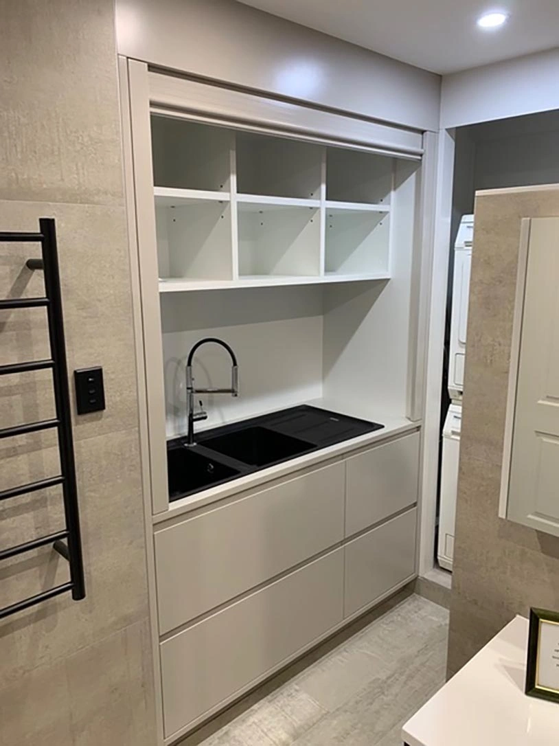 A functional bathroom layout including a sink, toilet, and a cabinet for keeping toiletries neatly stored