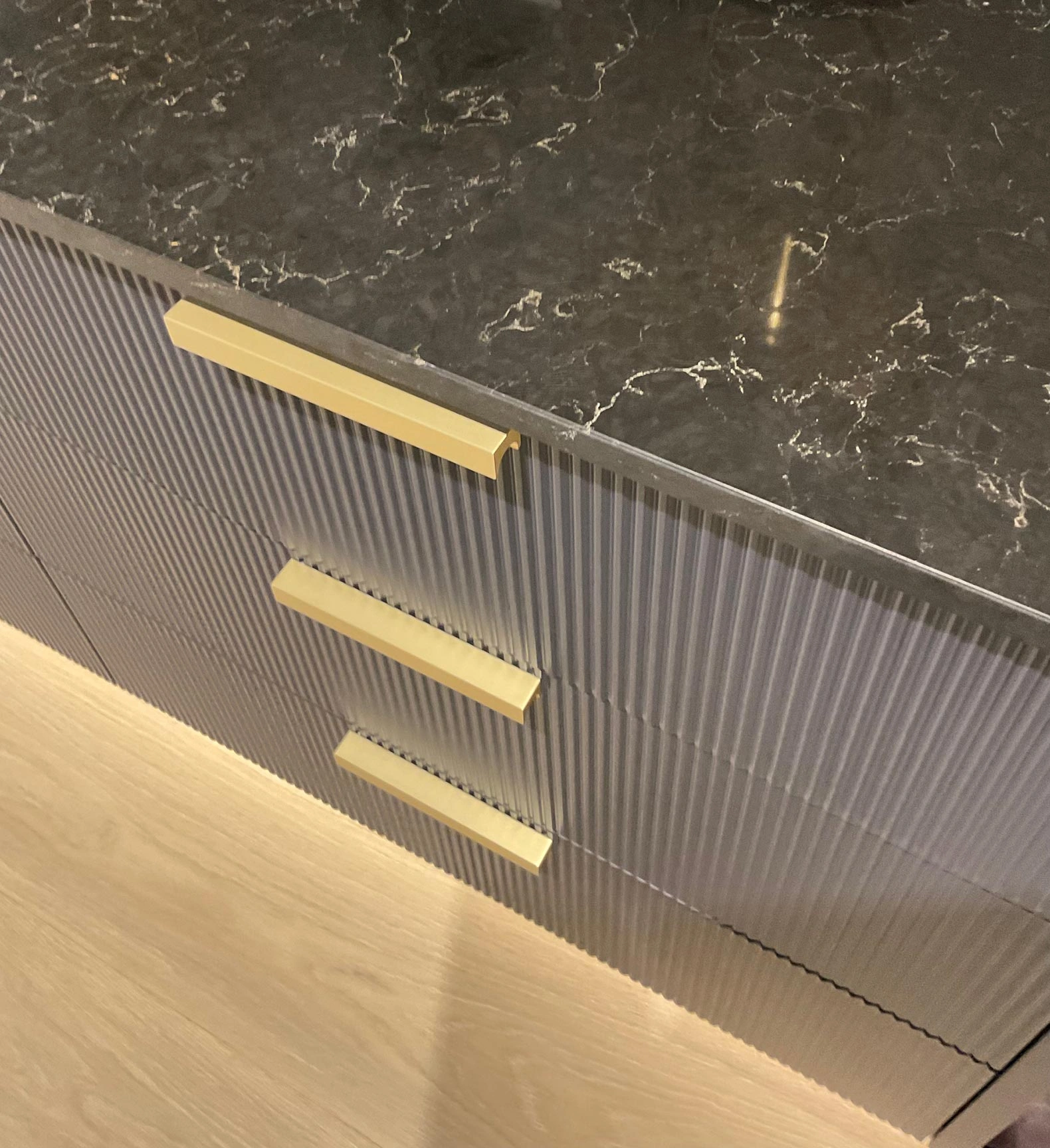 Close-up of a marble countertop featuring elegant gold handles