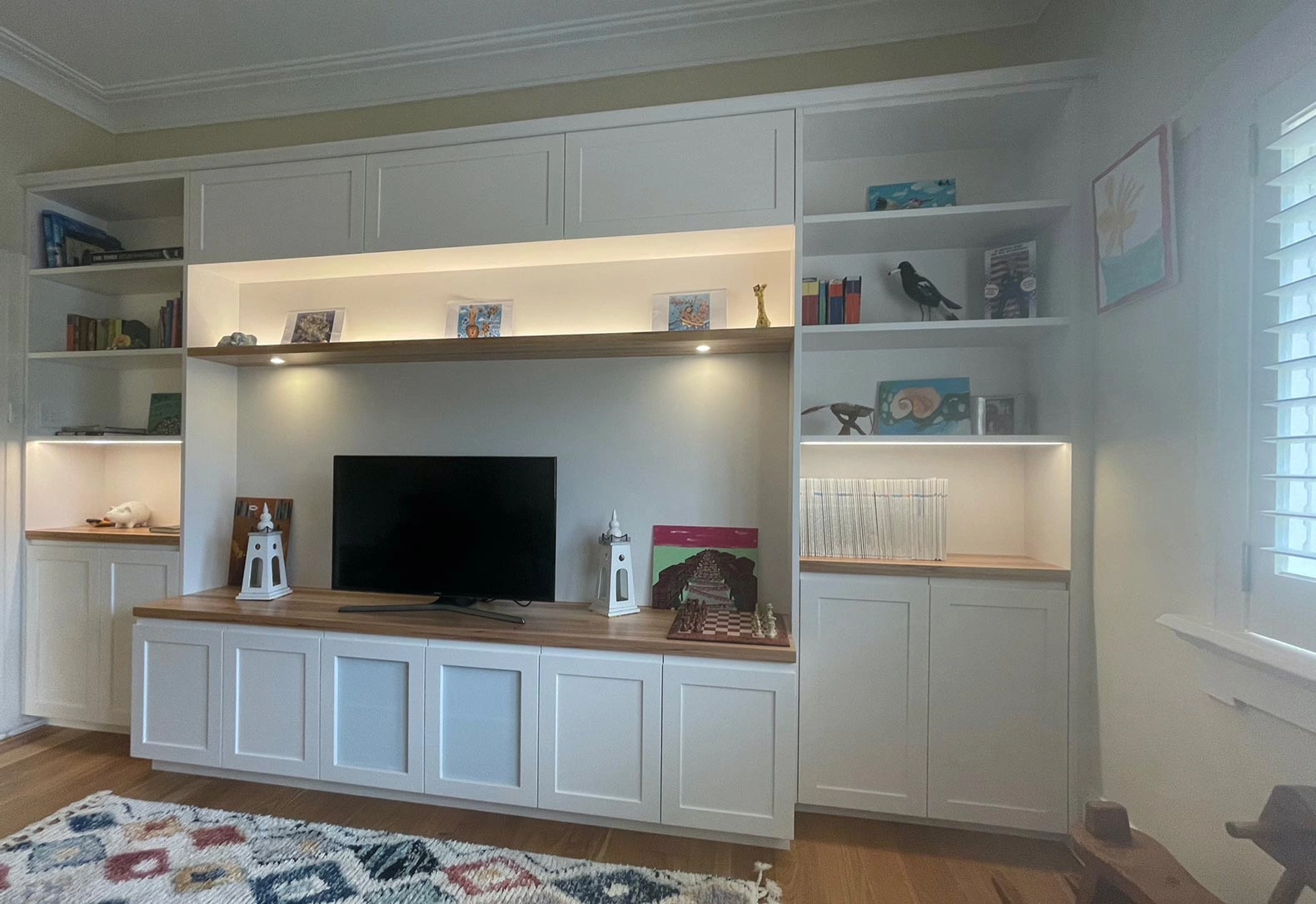 Well-designed living room featuring built-in shelves and a television