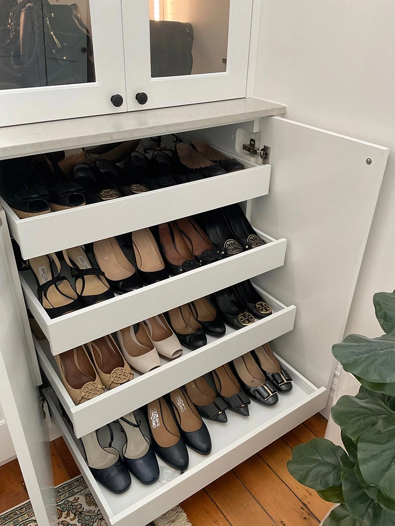 Stylish shoe rack featuring several shelves filled with various shoes