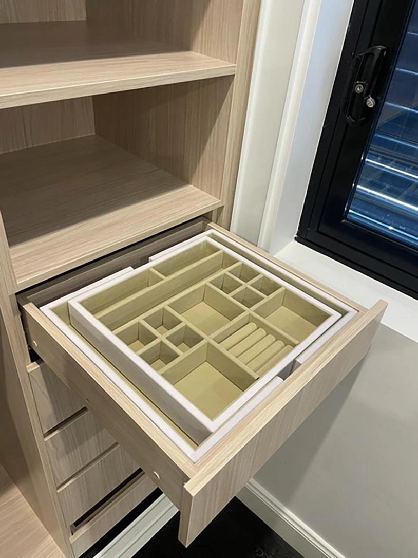 Wooden drawer containing smaller drawers and a tray