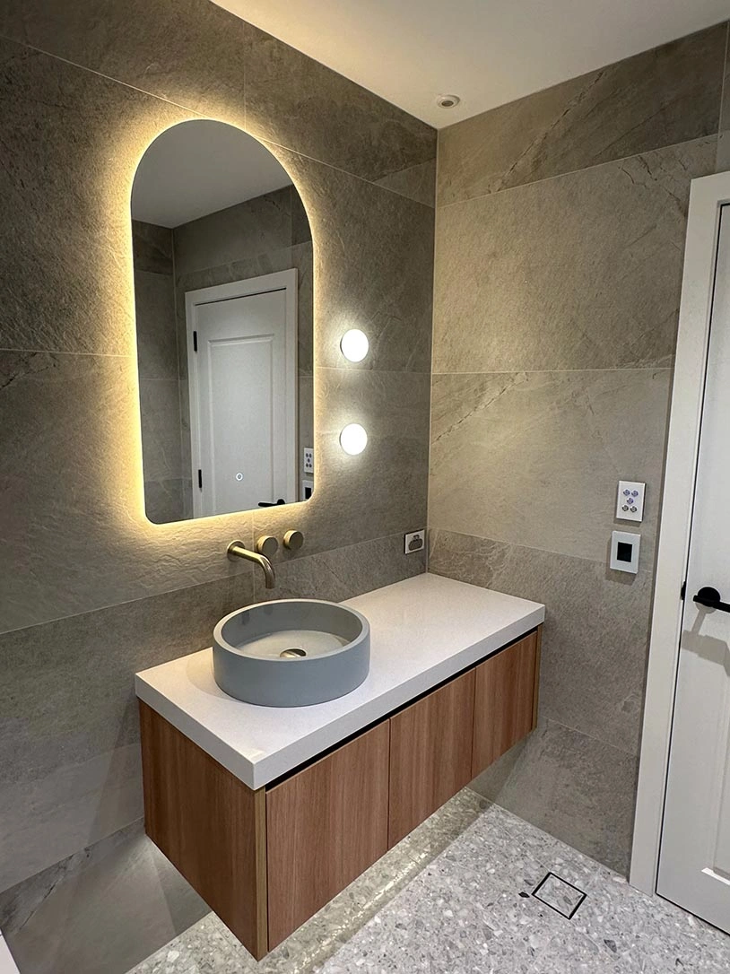 A contemporary bathroom showcasing a minimalist sink and a mirror