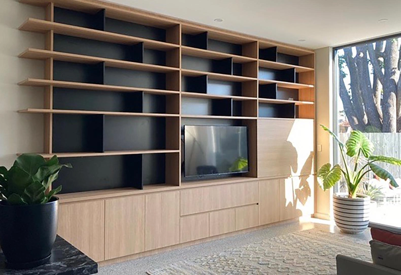 Modern living room with a television and bookshelves