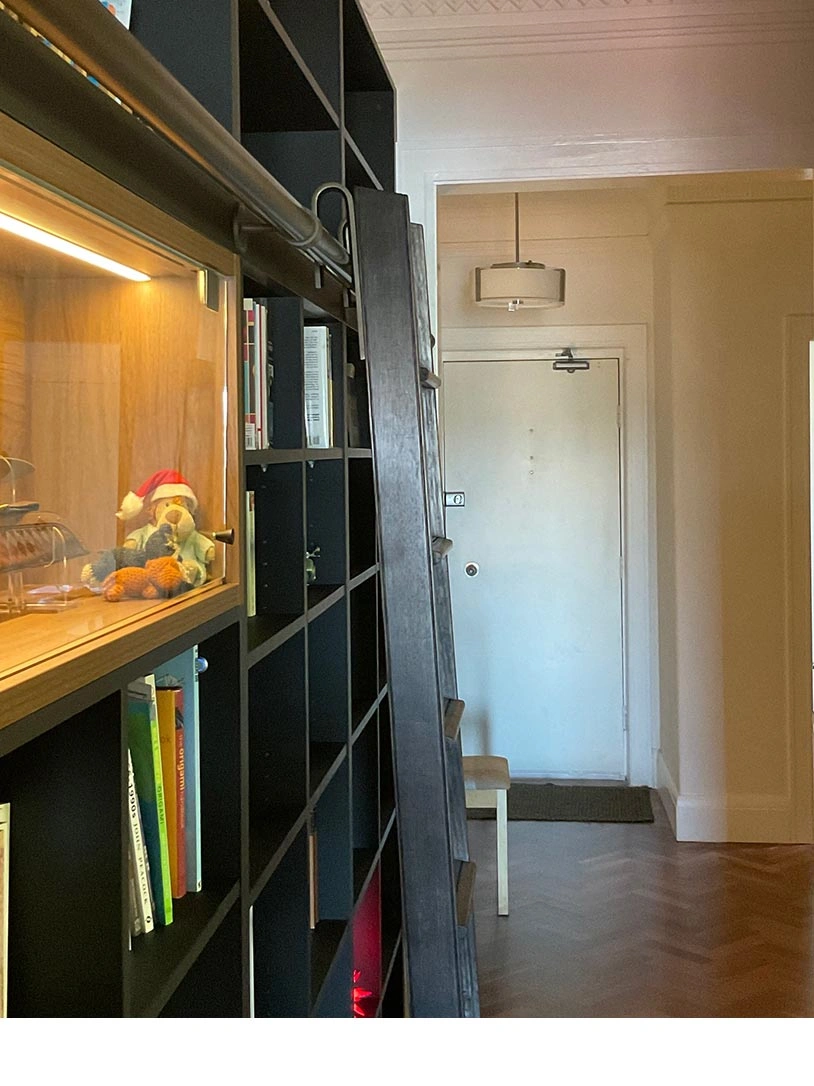 A wooden bookshelf filled with various books