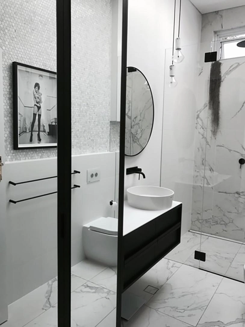 Elegant bathroom design with a polished marble floor and contrasting black and white walls