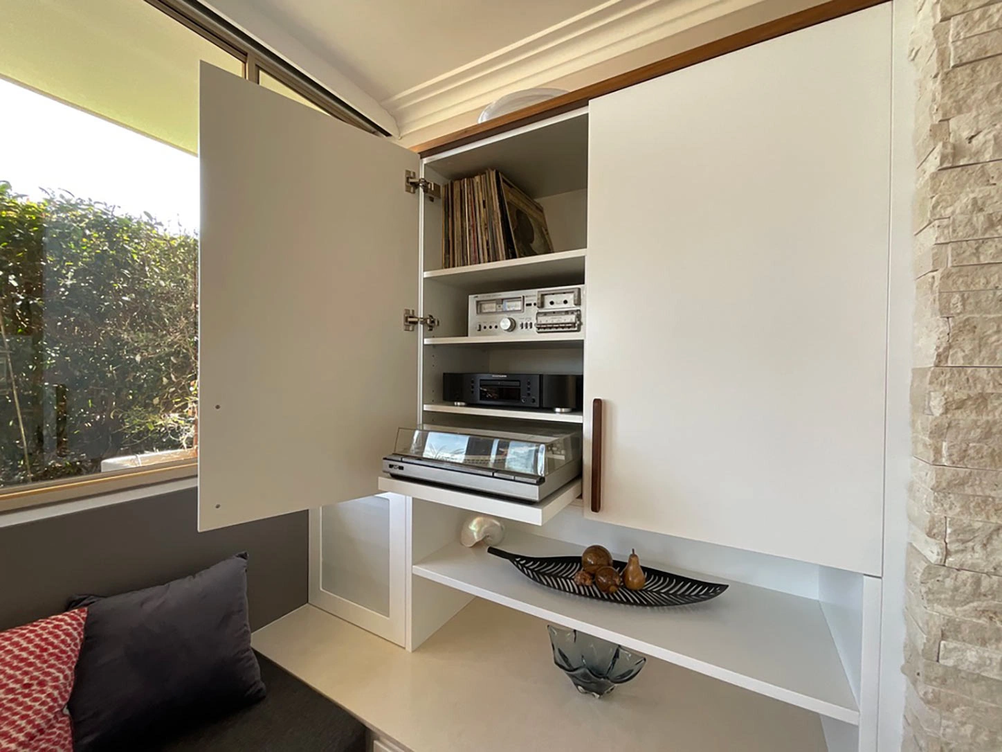 A compact room showcasing a plush couch and a sleek cabinet