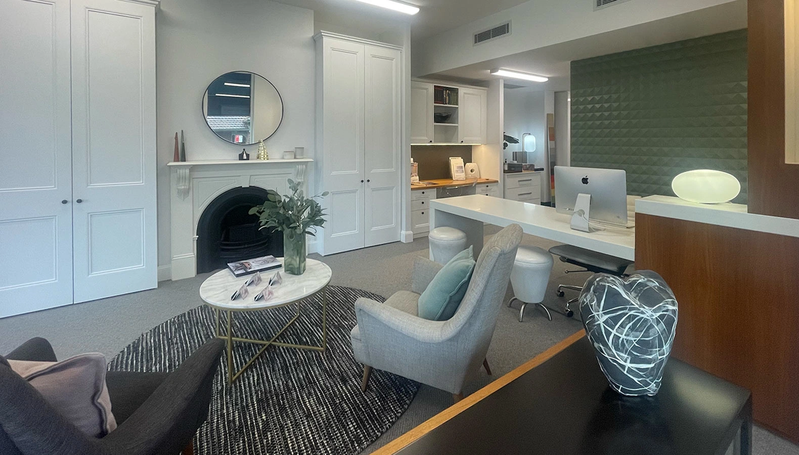 An elegant office design with a fireplace and a desk