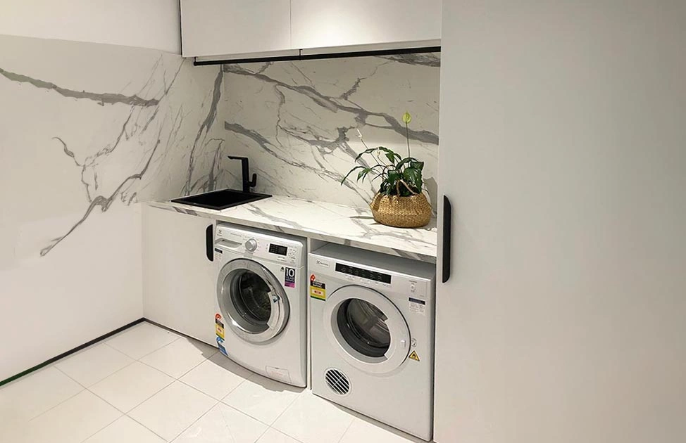 Spacious white laundry room equipped with a washer and dryer